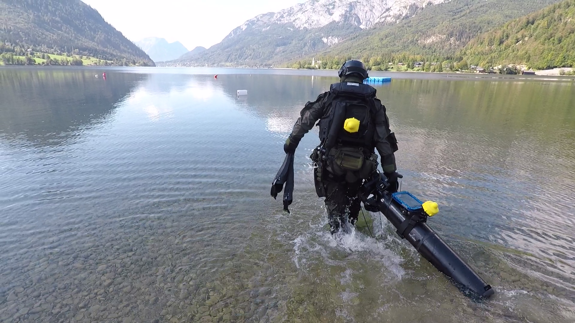 Diver entering the water with UWIS units and a DPV